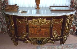 A LOUIS XVI STYLE GILT BRONZE MOUNTED FRUITWOOD, MAHOGANY AND FLOWER HEAD TRELLIS MARQUETRY COMMODE AFTER THE MODEL BY JEAN-HENRI RIESENER
Paris, circa 1890s 